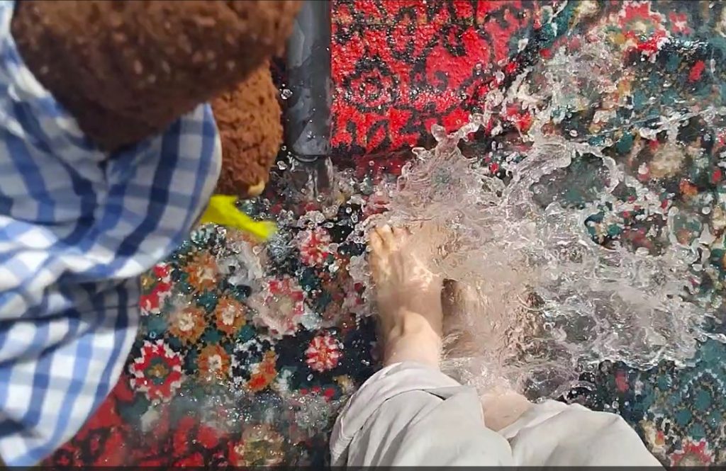 Feet in water ona rug overwatched by Bearsac the teddy bear