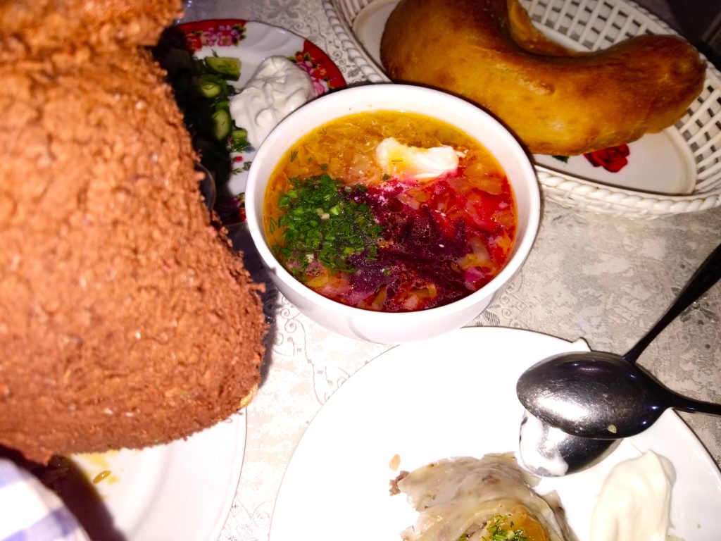 Bearsac the teddy bear in looking at a bowl of soup.