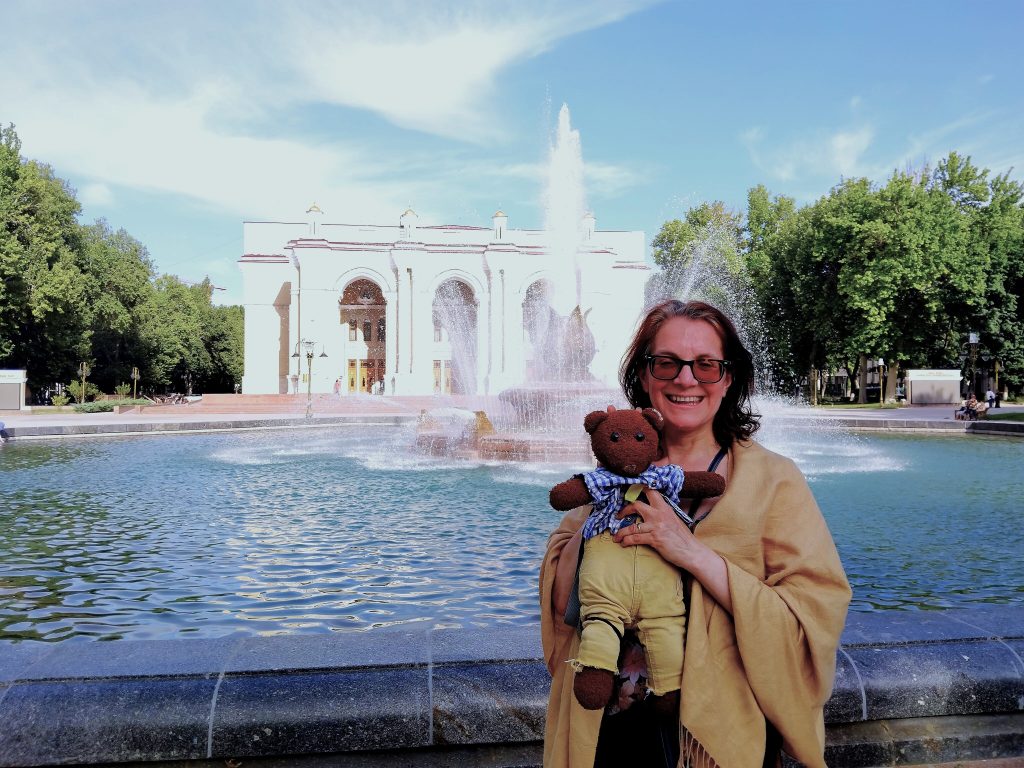 Bearsac the teddy bear held by his human in the foreground of
