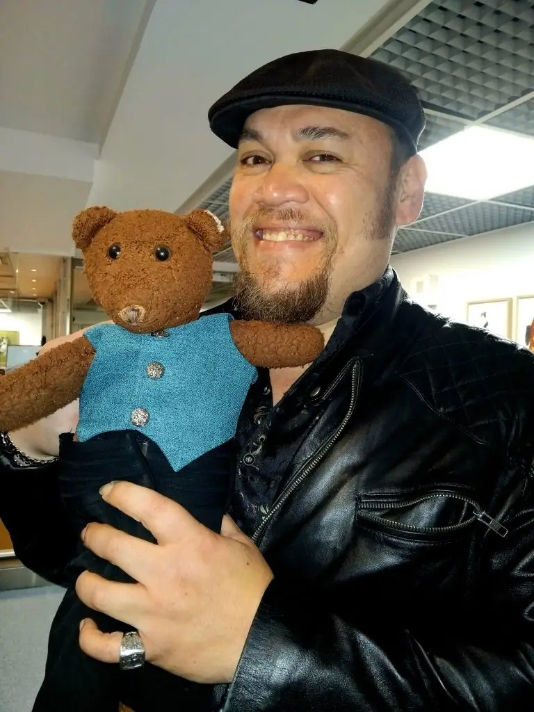 Quinn Kelsey holding Bearsac the teddy bear