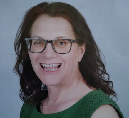 Head and shoulders photo of Debra wearing green, for the About page.