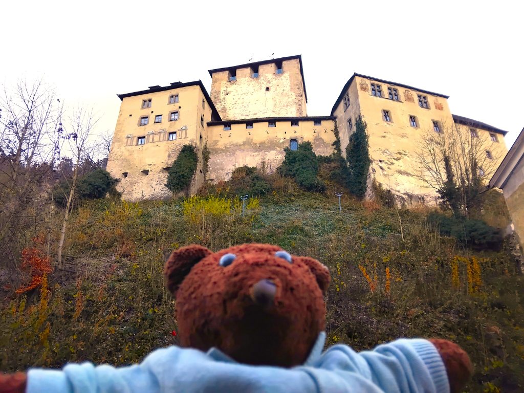 Bearsac the teddy bear in forground of Feldkirch Schattenburg Castle