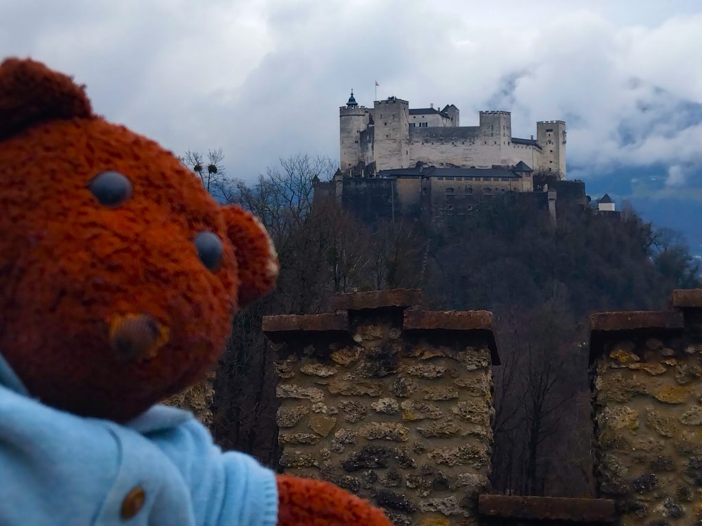 Bearsac the teddy bear in forground of Hohensalzburg Fortress