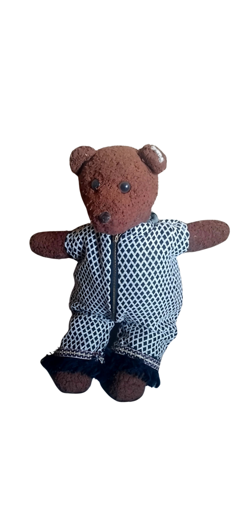 Bearsac the teddy bear wearing black and white onesie with fringed hem