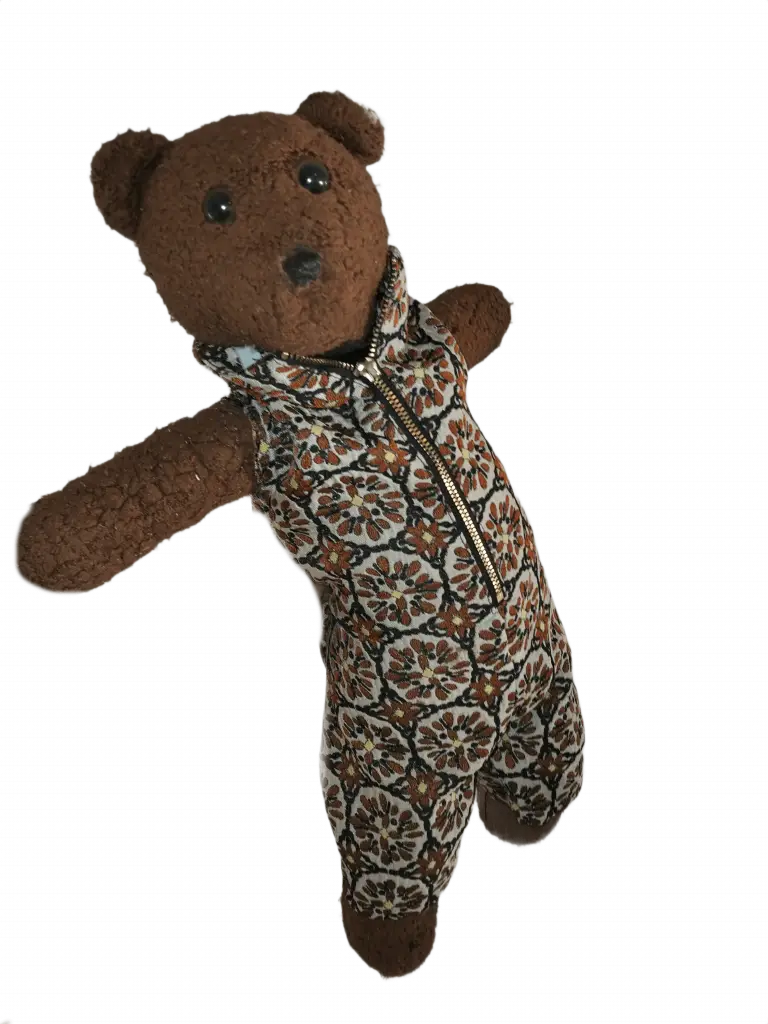 Bearasc the teddy bear wearing a sleeveless onsie in Autumn browns pattern.