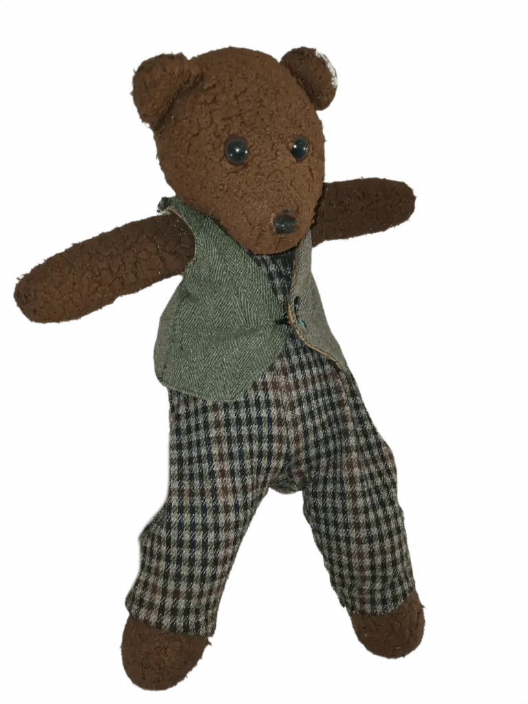 Bearasc the teddy bear wearing a greyish green waistcoat and brown checked trousers.