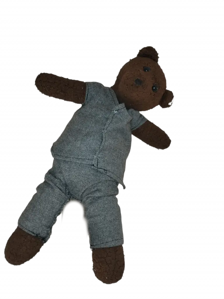 Bearasc the teddy bear wearing a mid-grey sleeveless suit.