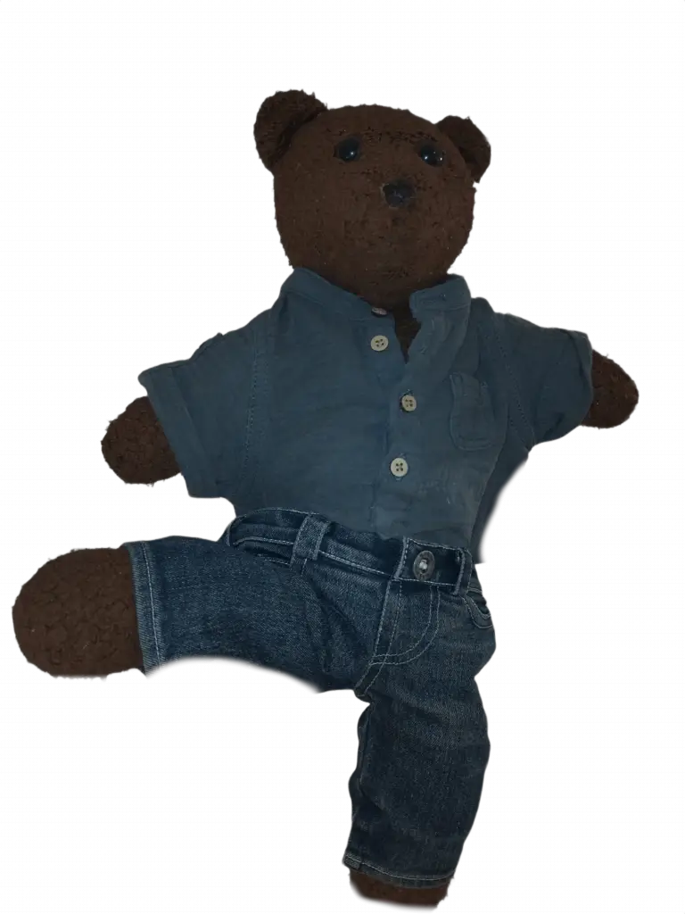 Bearasc the teddy bear wearing blue jeans and a grey shirt.