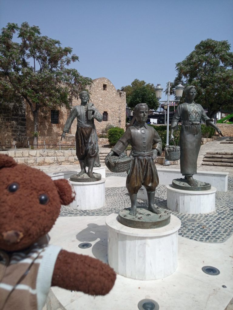 Bearsac the teddy bear in forground of People Cyprus monument