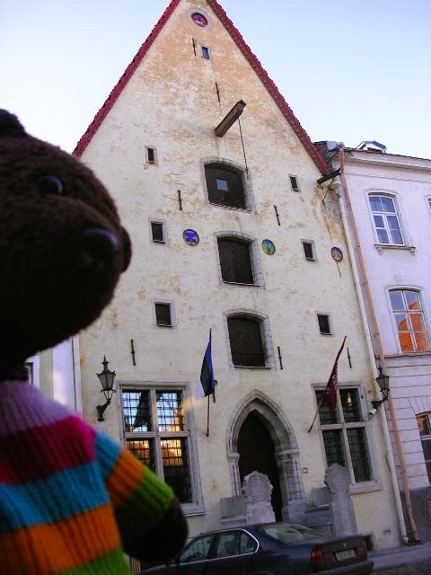 Bearsac in the foreground of a building with a furniture hook and loading doors on each floor.