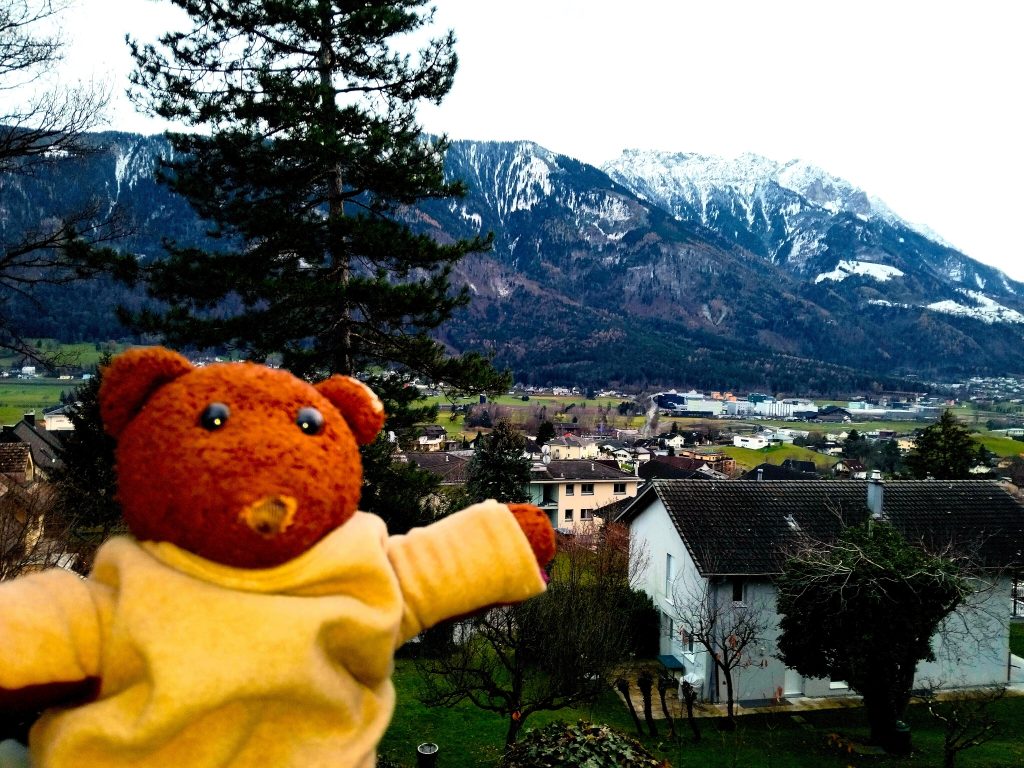 Bearsac the teddy bear in forground of a view from Mauren