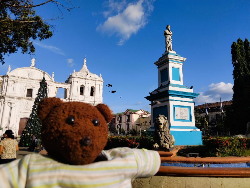 Bearsac the teddy bear in foreground of church and monument.