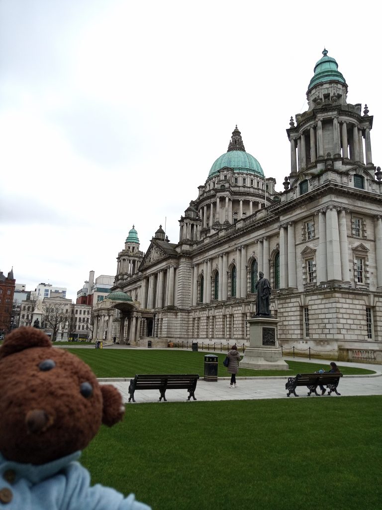 Bearsac the teddy bear in forground of Belfast City Hall