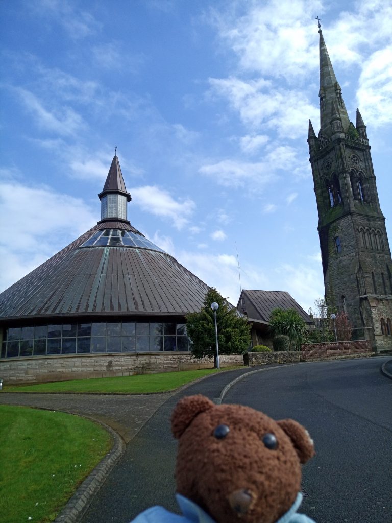 Bearsac the teddy bear in forground ofcHolywood church
