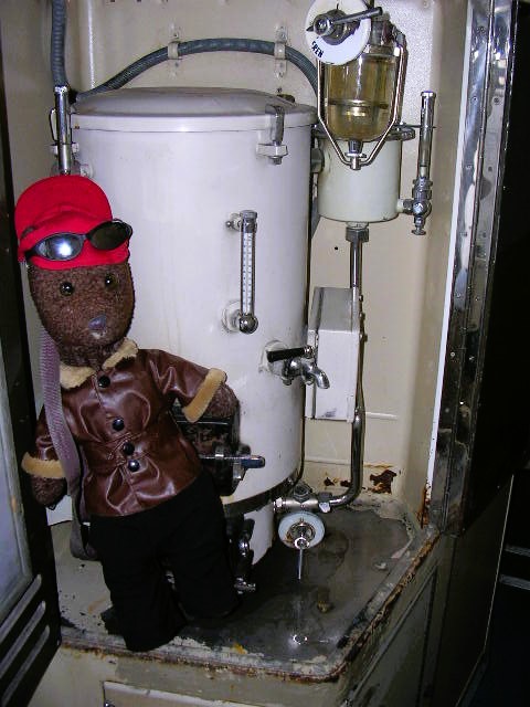 Bearsac in the teddybear besides a train samover.