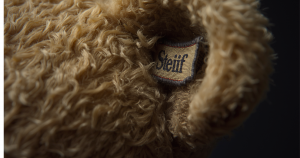 Close-up image showing a lable ina teddy bear's ear.